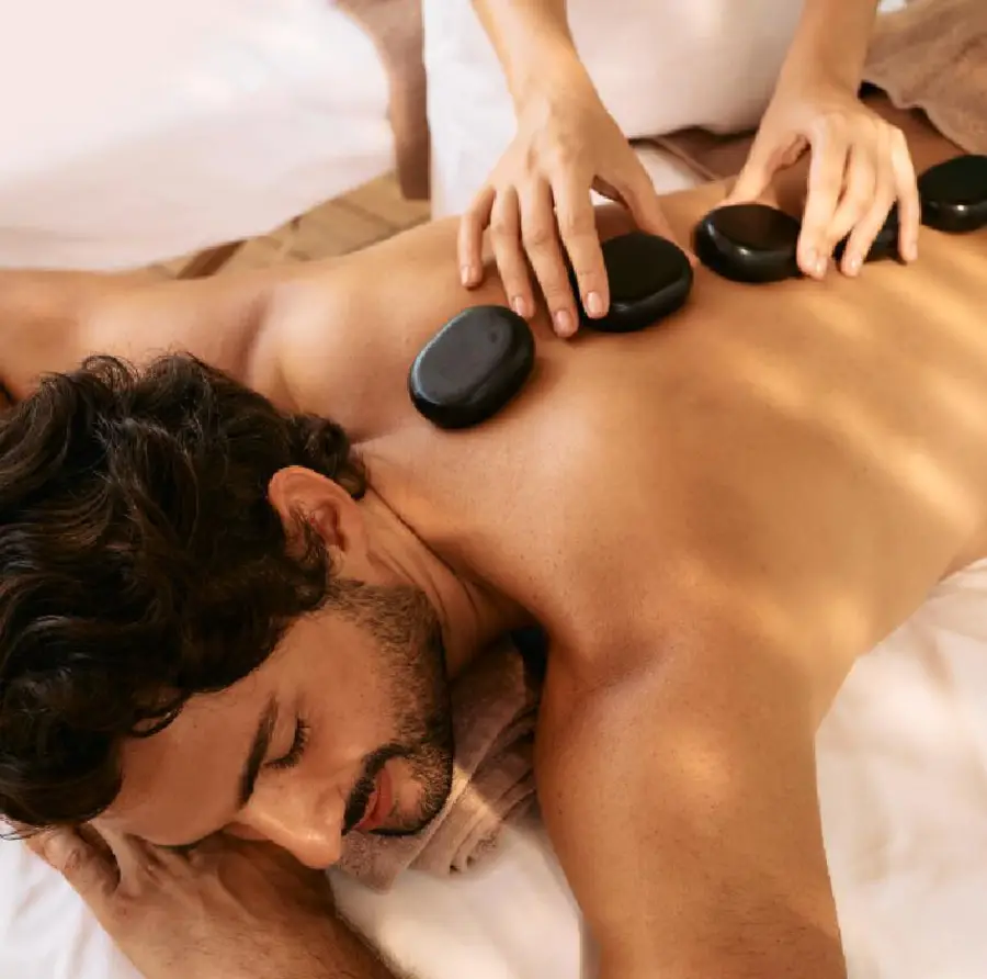 A guest receiving a hot-stone treatment