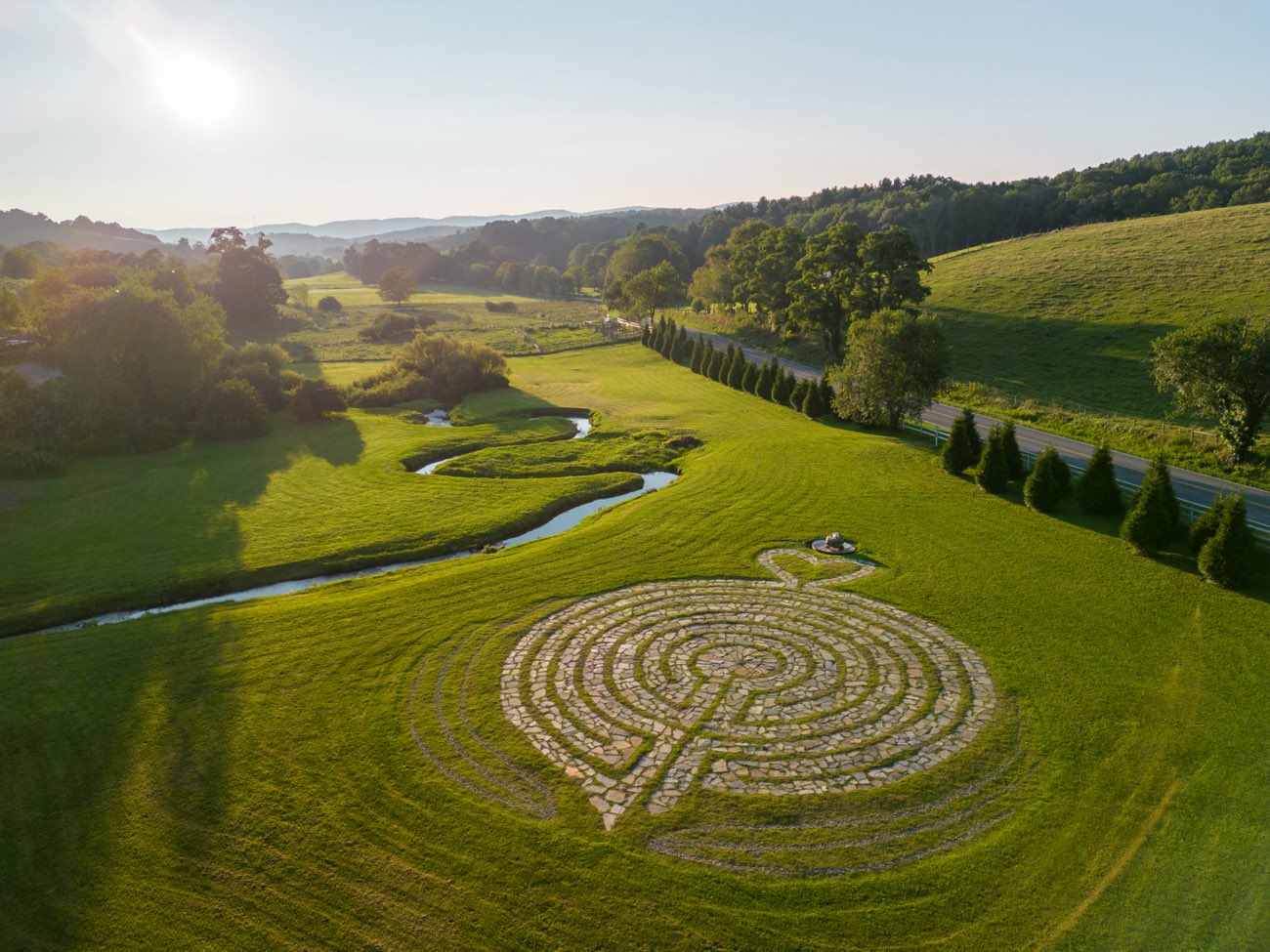 The walking labyrinth from above, beside the creek at golden hour