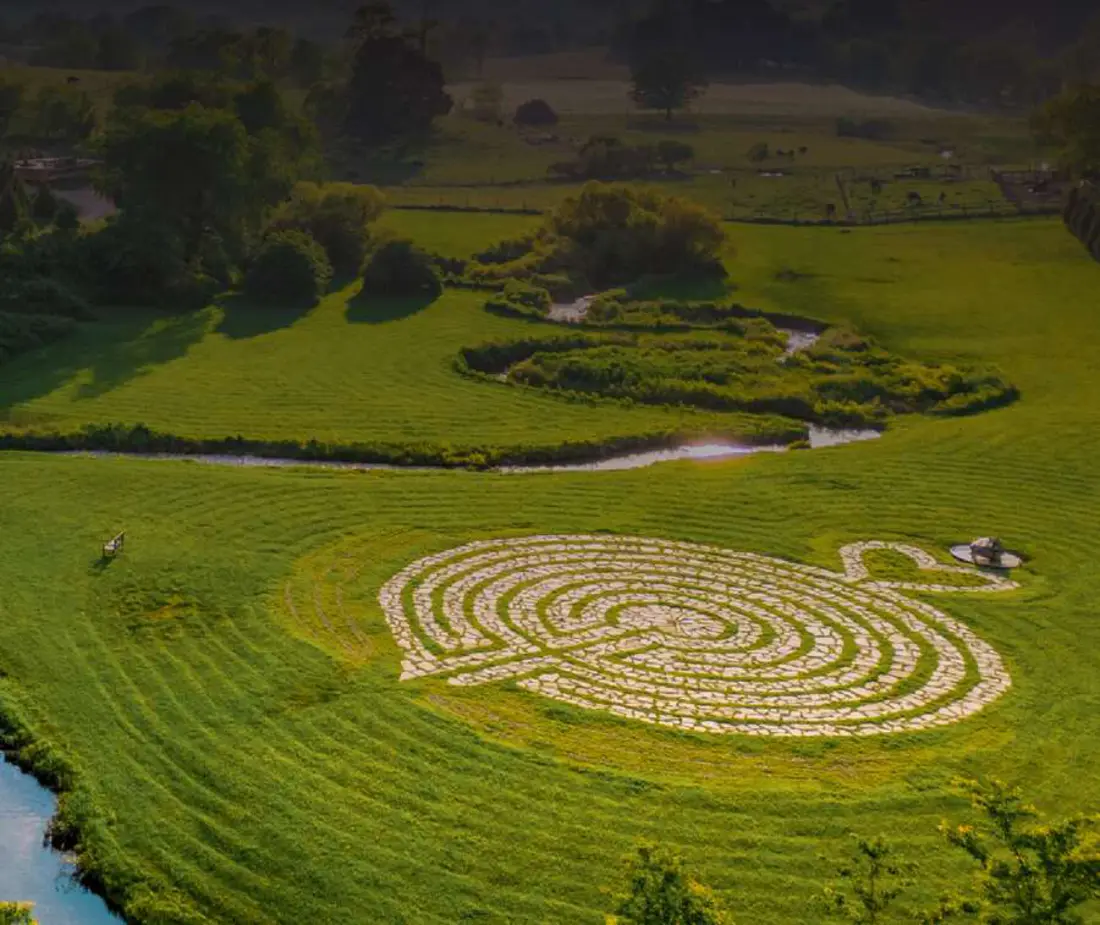 The stone labyrinth set in the pastures at Eupepsia, the creek winding past