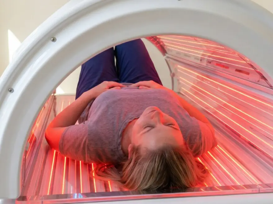 A guest in the red-light therapy bed